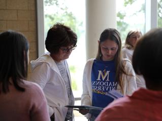 Small group conducting a reading inside the Franciscan Center gathering area